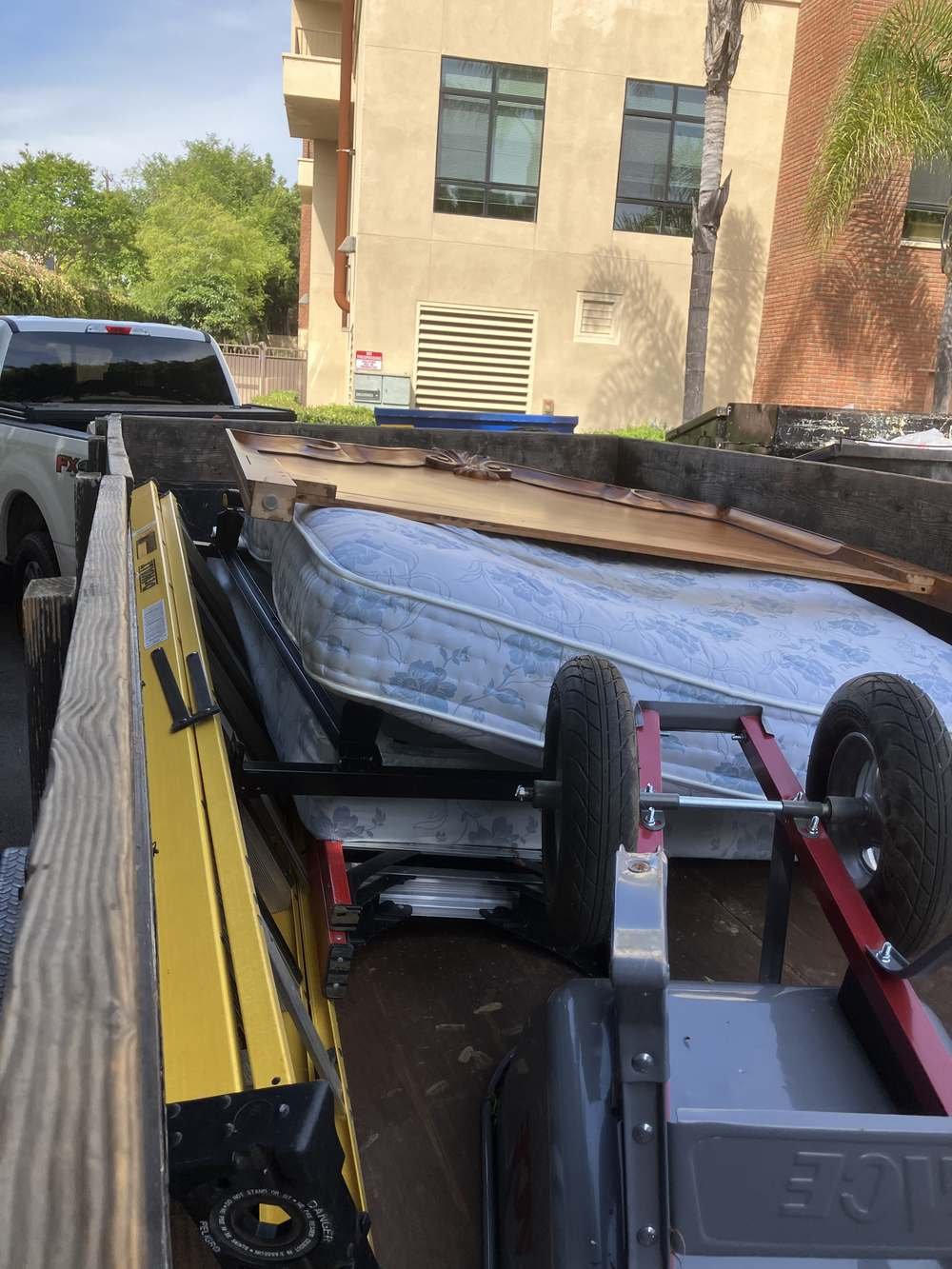 Mattress and bed frame loaded for removal